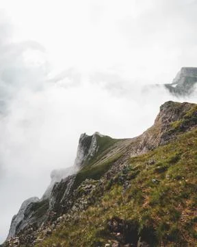 Steep mountain formation with clouds Stock Photos