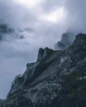 Steep mountain formation with clouds Stock Photos