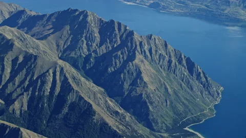 Steep mountains beside large lake aerial Stock Footage 155488985