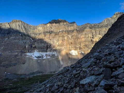 Steep mountains between a valley during sunrise Stock Photos