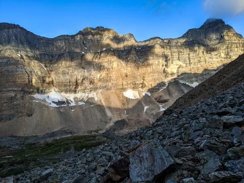 Steep mountains between a valley during sunrise Stock Photos
