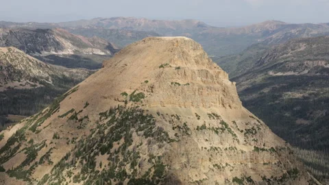 Steep, pointed mountain with other mountains in background, 4K Stock Footage 231546546