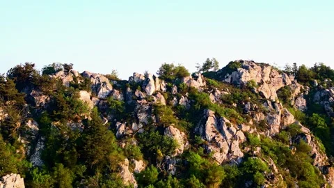 Steep Rock Face and Peak Covered with Pine Forest. Natural Landscape Stock Footage 318664459