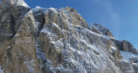 Steep Rock Face of Sella Mountain in Winter covered in Snow. Aerial Drone view Stock Footage 150079437