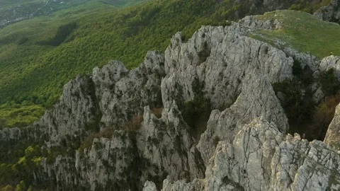 Steep rocky mountain ridges on the edge of plateau. Beautiful sharp cracked r Stock Footage 165337948