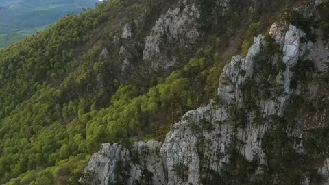 Steep rocky mountain ridges on the edge of plateau. Beautiful sharp cracked r Stock Footage 165337977