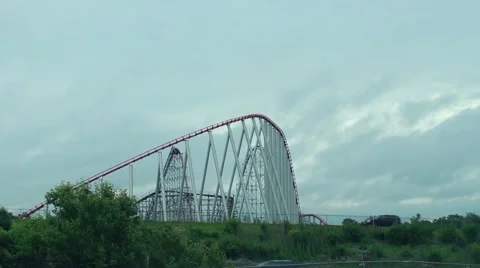 Steep rollercoaster going down against cloudy sky Stock Footage 40254782