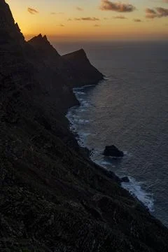 Steep Sea Cliffs at Sunset With Waves Far Below Stock Photos