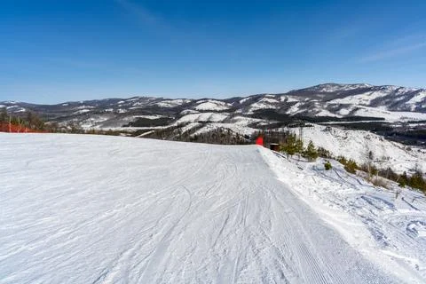 Steep ski slope with red restrictive net against the backdrop of picturesqu.. Stock Photos