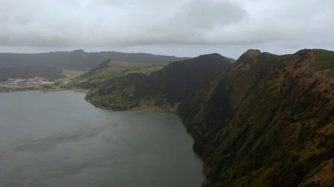 Steep slopes of volcano caldera. Volcanic lake between mountains. Aerial of Sete Stock Footage 121269945