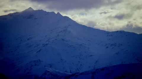 Steep snow covered mountain in shade Stock Footage 159718592