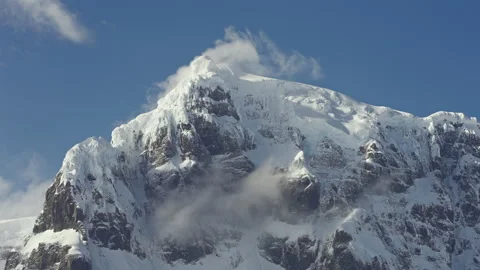 Steep Snowy Mountain Cliff with Blowing Cloud Vídeos de archivo 335079333