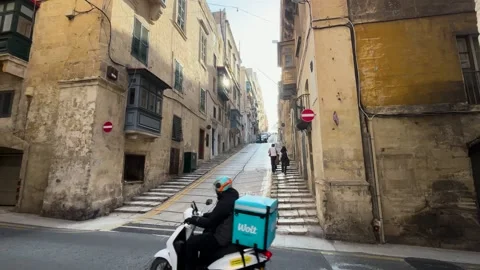 Steep stepped street one way signs wolt delivery scooter rider descending Видео 343677202