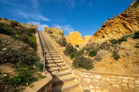 Steep steps leading down to explore the sea caves and ocean at Ponta da Pieda Stock Photos