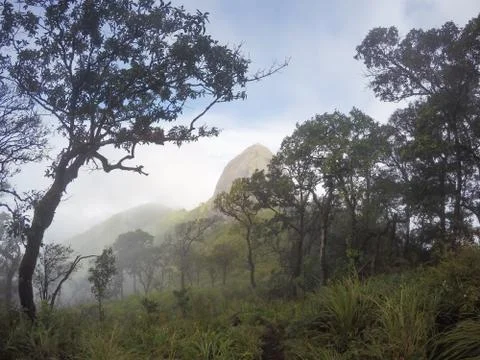 Steep view of the front of the hill that has clouds around Stock Photos