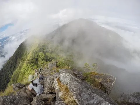 Steep view of the front of the hill that has clouds around Stock Photos