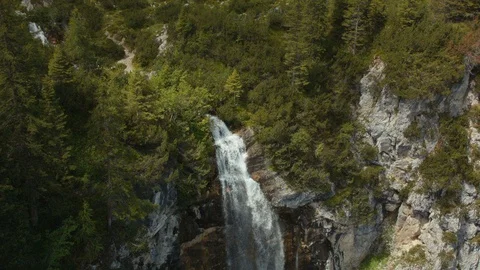 A steep waterfall opens up in green nature Stock Footage 101904203