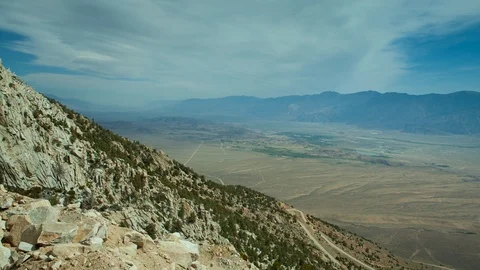 Steep winding mountain pass road and view over valley Stock Footage 94804693