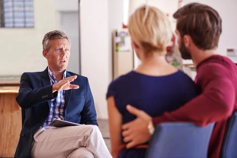 Steering them in the right direction. Young couple discussing investment plans Stock Photos