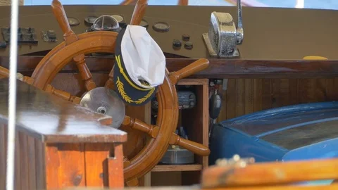 Steering Wheel and Captain Hat Stock Footage 77351653