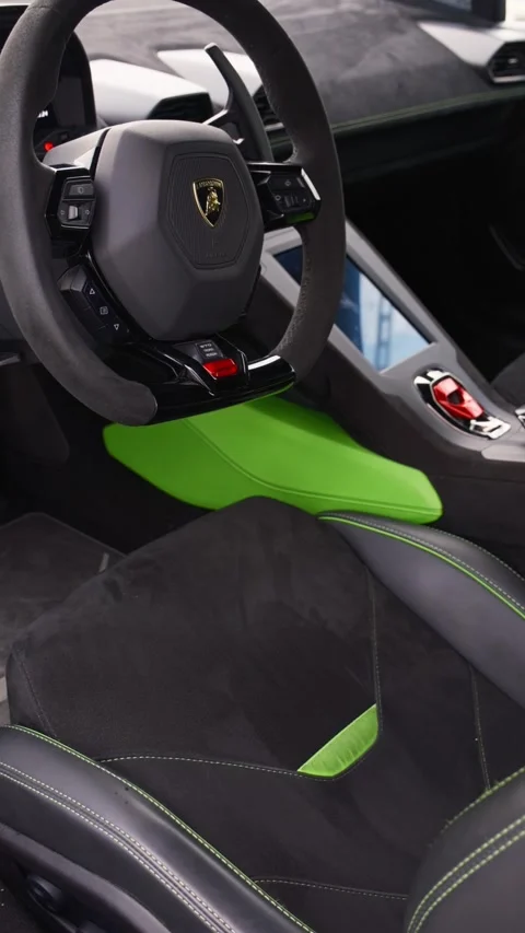 Steering wheel and control panel of an expensive sports car parked on the road Stock Footage 279459811