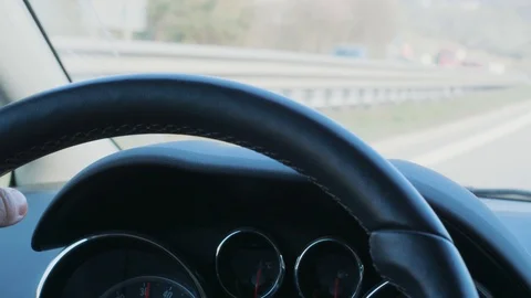 Steering wheel and hand during car driving on day highway Stock Footage 105966464