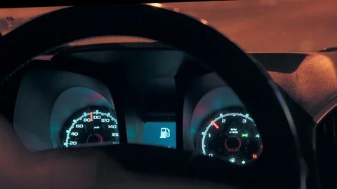 Steering wheel and speedometer in a car while driving at night Stock Footage 127208011