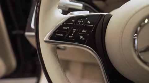 The steering wheel of the car is a close-up with the logo of the Mercedes Stock Footage 256153184