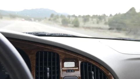Steering wheel in a car driving fast on highway Stock Footage 75770258