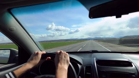 Steering wheel of a car with a man's hand, a man driving a car in the mount.. Stock Footage 314280583