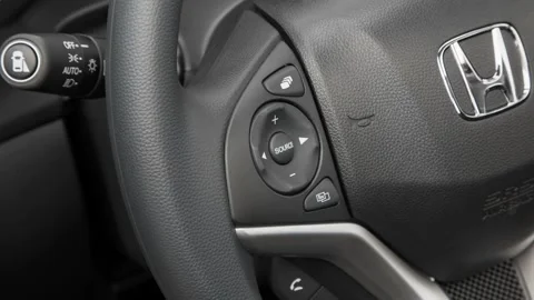 Steering wheel control buttons close up 2016 Honda Fit EX Stock Footage 159857719