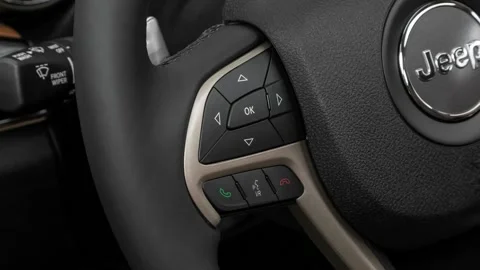 Steering wheel control buttons close up 2016 Jeep Grand Cherokee Summit Stock Footage 159880296