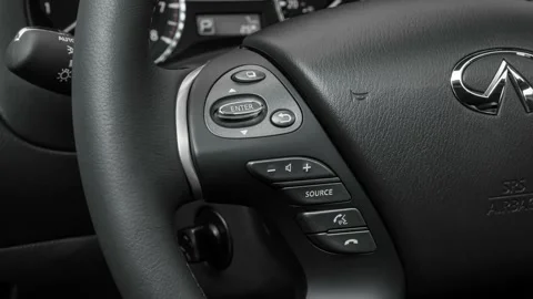 Steering wheel control buttons close up 2016 Infiniti QX60 3.5 Stock Footage 159889661