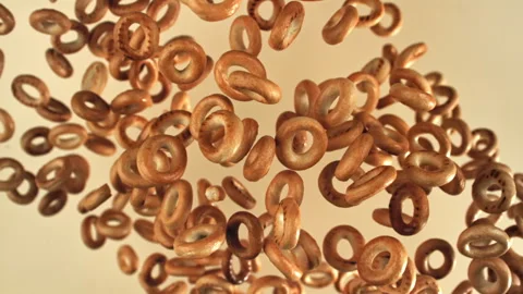 The steering wheel crackers fly up and fall on a light background. Filmed on a Stock Footage 322821309