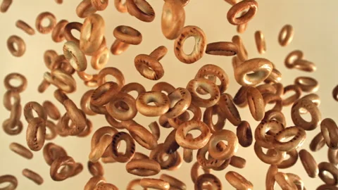 The steering wheel crackers fly up and fall on a light background. Filmed on a Stock Footage 322821690