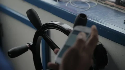 Steering Wheel of a Ferry While Captain is Texting Stock Footage 61080635