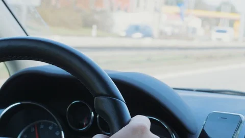 Steering wheel with hand during car driving on day highway Stock Footage 105947871