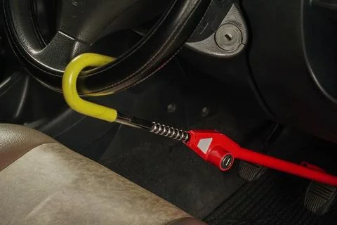 Steering wheel lock device attached to a car interior for security Stock Photos
