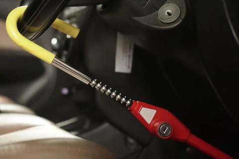 Steering wheel lock device installed for vehicle security in a car interior 스톡 사진