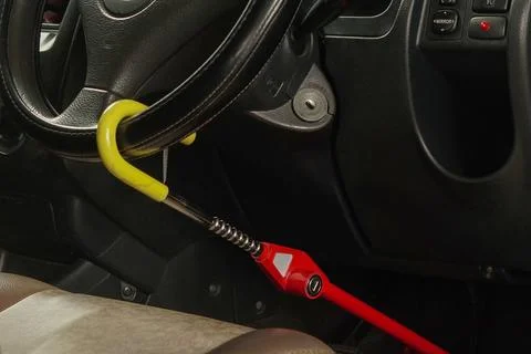 Steering wheel lock security device installed on a car steering wheel 스톡 사진
