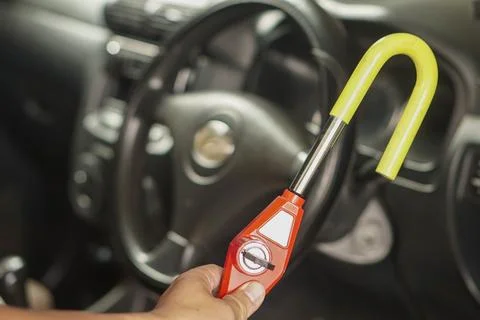 Steering wheel lock security device installed on a car steering wheel 스톡 사진