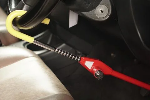 Steering wheel lock security device installed on a car steering wheel Stock Photos