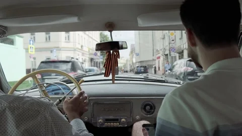 Steering wheel of an old car while driving. Driver's hands drive the car while d Stock Footage 137572821