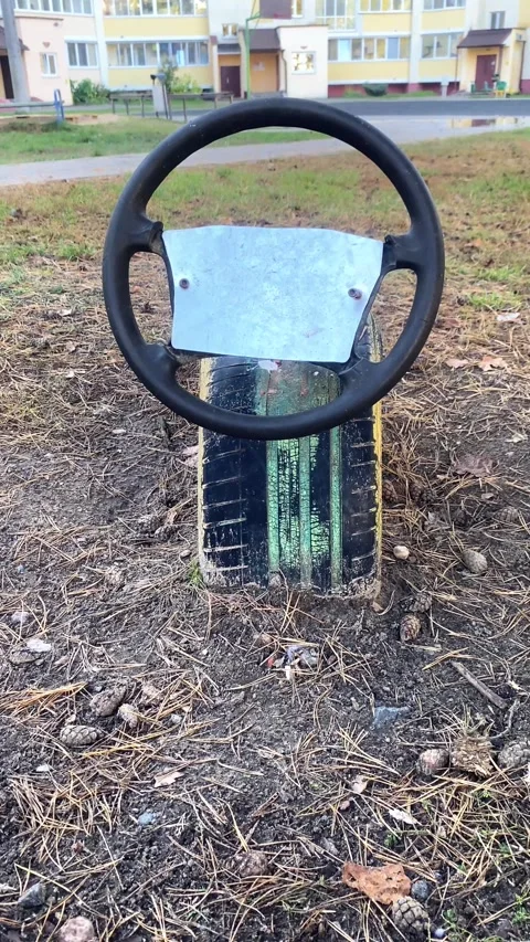 Steering wheel on the playground. Vertical video Stock Footage 287943351