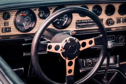 Steering wheel, speedometer, revs, clock dials, radio scale, buttons and knobs Stock Photos