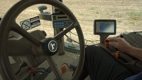 Steering wheel of a tractor, the steering wheel works automatically by the GPS Stock Footage 93623741