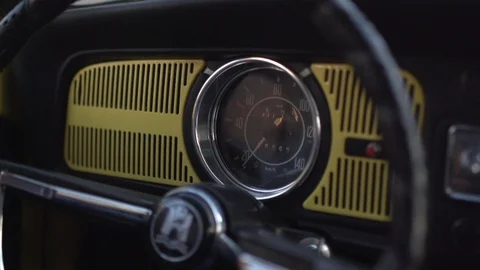 Steering wheel of a vintage car while man hand driving in city traffic Stock Footage 99101324