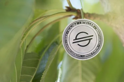 Stellar digital crypto currency. Stack of silver coins. Cyber money. Stock Photos