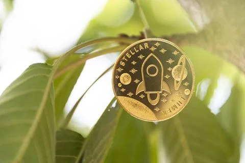 Stellar digital crypto currency. Stack of silver coins. Cyber money. Stock Photos