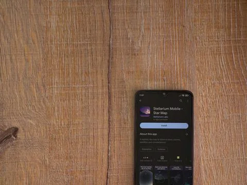Stellarium - Star Map app play store page on smartphone on wooden background Stock Photos